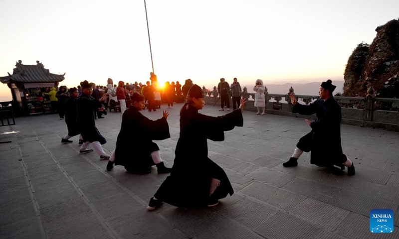 Taoist priests practice martial arts at golden peak on the Wudang Mountain in Shiyan City in central China's Hubei Province, Nov. 29, 2024. Tai Chi, a centuries-old Chinese martial art focusing on both internal and external practices, involves a series of slow, gentle movements and physical postures, a meditative state of mind, and controlled breathing. Statistics show that over 100 million people across more than 150 countries and regions practice Tai Chi, with about 30,000 foreigners traveling to the Wudang Mountain annually to learn and experience it. Photo: Xinhua