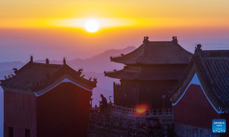 An aerial drone photo shows a view of golden peak on the Wudang Mountain in Shiyan City in central China's Hubei Province, Nov. 29, 2024. Tai Chi, a centuries-old Chinese martial art focusing on both internal and external practices, involves a series of slow, gentle movements and physical postures, a meditative state of mind, and controlled breathing. Statistics show that over 100 million people across more than 150 countries and regions practice Tai Chi, with about 30,000 foreigners traveling to the Wudang Mountain annually to learn and experience it. Photo: Xinhua