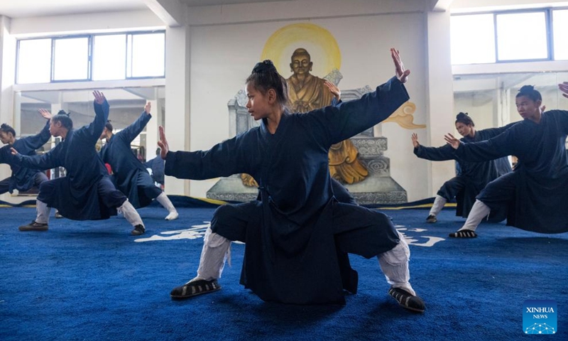 Students practice Tai Chi at a martial arts school in Shiyan City in central China's Hubei Province, Nov. 28, 2024. Tai Chi, a centuries-old Chinese martial art focusing on both internal and external practices, involves a series of slow, gentle movements and physical postures, a meditative state of mind, and controlled breathing. Statistics show that over 100 million people across more than 150 countries and regions practice Tai Chi, with about 30,000 foreigners traveling to the Wudang Mountain annually to learn and experience it. Photo: Xinhua