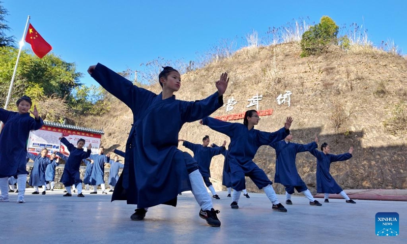 Students practice Tai Chi at a martial arts school in Shiyan City in central China's Hubei Province, Nov. 28, 2024. Tai Chi, a centuries-old Chinese martial art focusing on both internal and external practices, involves a series of slow, gentle movements and physical postures, a meditative state of mind, and controlled breathing. Statistics show that over 100 million people across more than 150 countries and regions practice Tai Chi, with about 30,000 foreigners traveling to the Wudang Mountain annually to learn and experience it. Photo: Xinhua