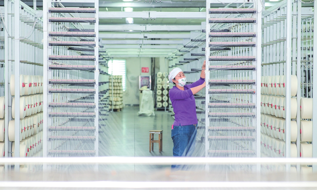 A worker is busy working on an intelligent production line at a medical textile company in Hutubi county, Northwest China's Xinjiang Uygur Autonomous Region on December 1, 2024. The county has promoted the transformation and upgrading of traditional industries, advancing the intelligent and green development of its knitting and medical sanitary materials sectors. Photo: VCG