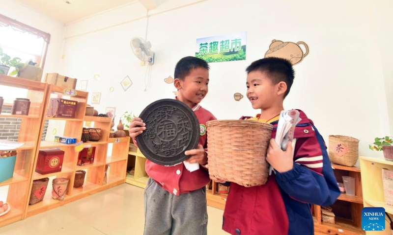 Children simulate buying tea at a kindergarten in Liubao Town of Cangwu County in Wuzhou City, south China's Guangxi Zhuang Autonomous Region, Dec. 3, 2024. In recent years, Liubao Town has introduced the promotion of Liubao tea culture into classrooms, offering a series of courses to advance the inheritance and development of the tea. Liubao tea-making technique is a UNESCO intangible cultural heritage subproject. Photo: Xinhua