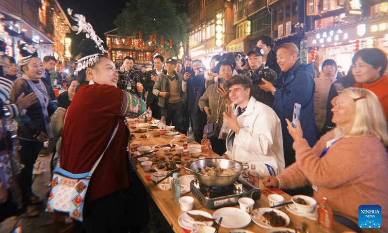 German blogger Robert Adolf (2nd R, front) and his mother Anna Adolf (1st R, front) attend a Dong New Year celebration at Zhaoxing Dong Village in Liping County, southwest China's Guizhou Province, Nov. 30, 2024. Photo: Xinhua