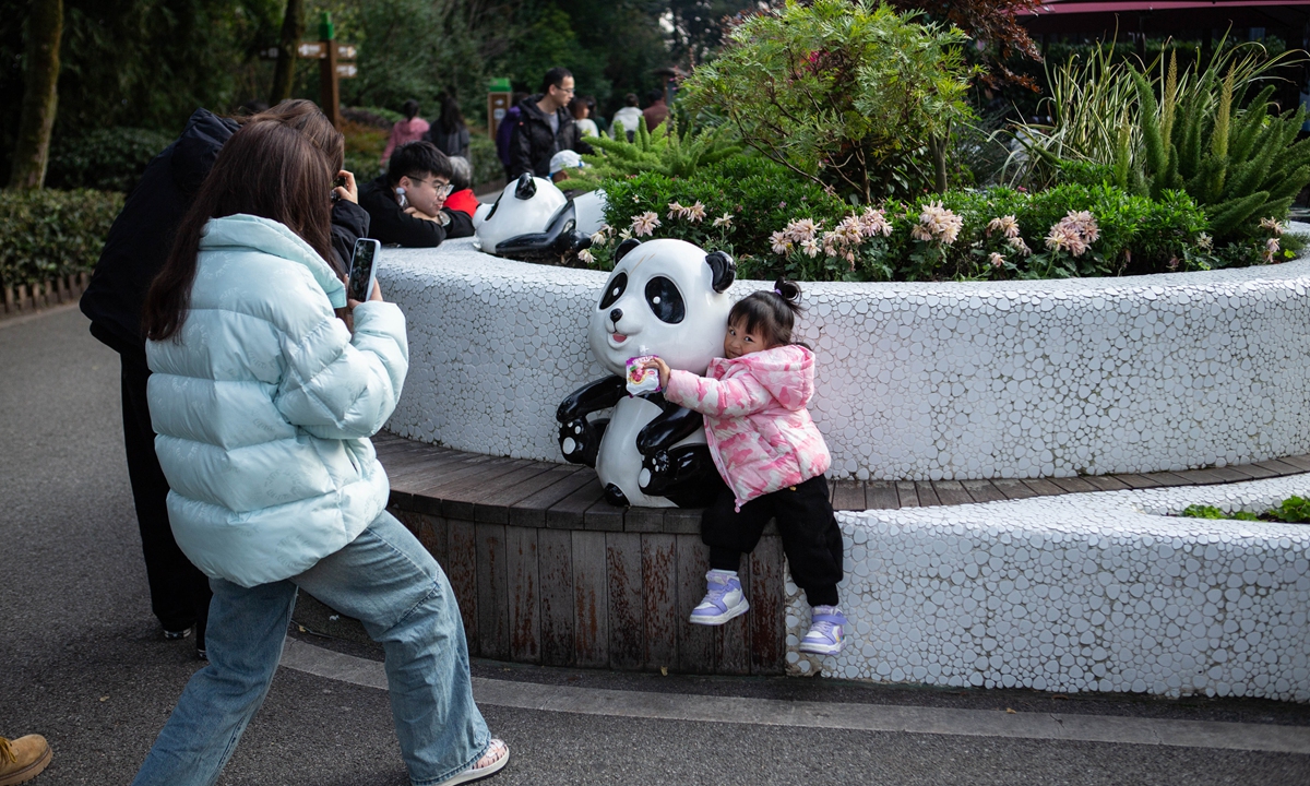Children select from an array of panda-themed souvenirs outside the Chengdu Research Base of Giant Panda Breeding. Photo: Shan Jie/GT 