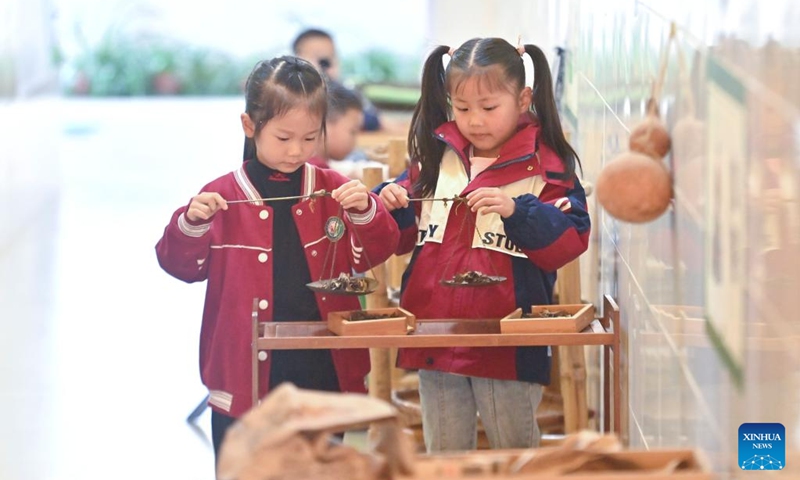Children simulate selling tea at a kindergarten in Liubao Town of Cangwu County in Wuzhou City, south China's Guangxi Zhuang Autonomous Region, Dec. 3, 2024. In recent years, Liubao Town has introduced the promotion of Liubao tea culture into classrooms, offering a series of courses to advance the inheritance and development of the tea. Liubao tea-making technique is a UNESCO intangible cultural heritage subproject. Photo: Xinhua