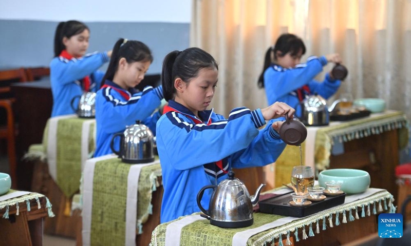Students have a tea art class at a school in Liubao Town of Cangwu County in Wuzhou City, south China's Guangxi Zhuang Autonomous Region, Dec. 3, 2024. In recent years, Liubao Town has introduced the promotion of Liubao tea culture into classrooms, offering a series of courses to advance the inheritance and development of the tea. Liubao tea-making technique is a UNESCO intangible cultural heritage subproject. Photo: Xinhua