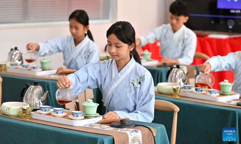 Students have a tea art class at Tangping Primary School in Liubao Town of Cangwu County in Wuzhou City, south China's Guangxi Zhuang Autonomous Region, Dec. 3, 2024. In recent years, Liubao Town has introduced the promotion of Liubao tea culture into classrooms, offering a series of courses to advance the inheritance and development of the tea. Liubao tea-making technique is a UNESCO intangible cultural heritage subproject. Photo: Xinhua