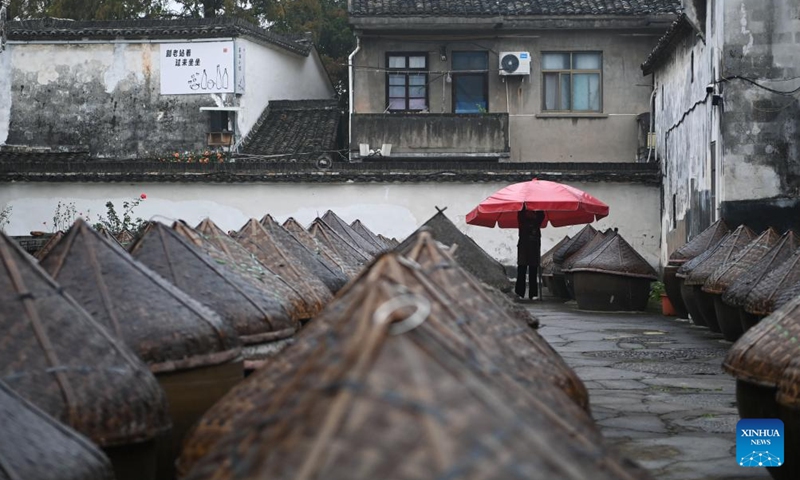 A villager works in a soybean paste workshop at the Youbu ancient town of Lanxi City, east China's Zhejiang Province, Dec. 5, 2024. Youbu ancient town, with a history of more than 1,300 years, is well known for its morning tea and photography elements and attracts a large number of tourists. (Photo: Xinhua)