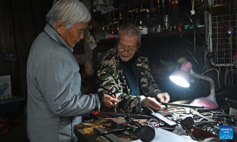A 91-year-old craftsman fixes a hand-held steelyard for a villager, at the Youbu ancient town of Lanxi City, east China's Zhejiang Province, Dec. 5, 2024. Youbu ancient town, with a history of more than 1,300 years, is well known for its morning tea and photography elements and attracts a large number of tourists. Photo: Xinhua