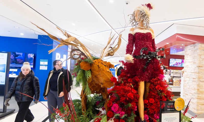 People walk past a floral installation on display during the Fleurs de Villes NO?L event in Toronto, Canada, on Dec. 6, 2024. The event is held here from Dec. 4 to Dec. 8, featuring 30 floral installations. Photo: Xinhua