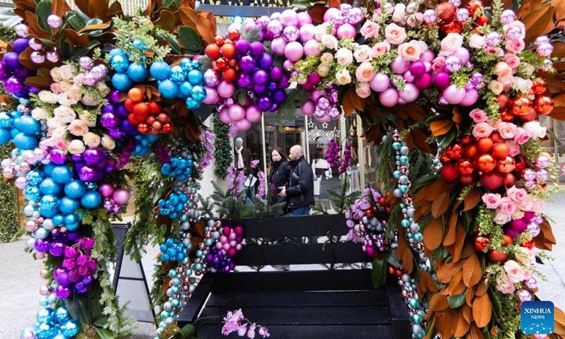 People walk past a floral installation on display during the Fleurs de Villes NO?L event in Toronto, Canada, on Dec. 6, 2024. The event is held here from Dec. 4 to Dec. 8, featuring 30 floral installations. Photo: Xinhua