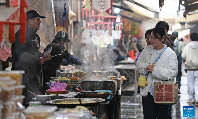 Tourists visit a morning tea street at the Youbu ancient town of Lanxi City, east China's Zhejiang Province, Dec. 5, 2024. Youbu ancient town, with a history of more than 1,300 years, is well known for its morning tea and photography elements and attracts a large number of tourists. Photo: Xinhua