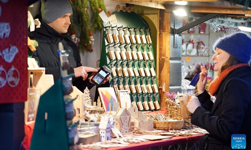 A vendor sells handcraft products at a Christmas market in Riga, Latvia, Dec. 7, 2024. Photo: Xinhua