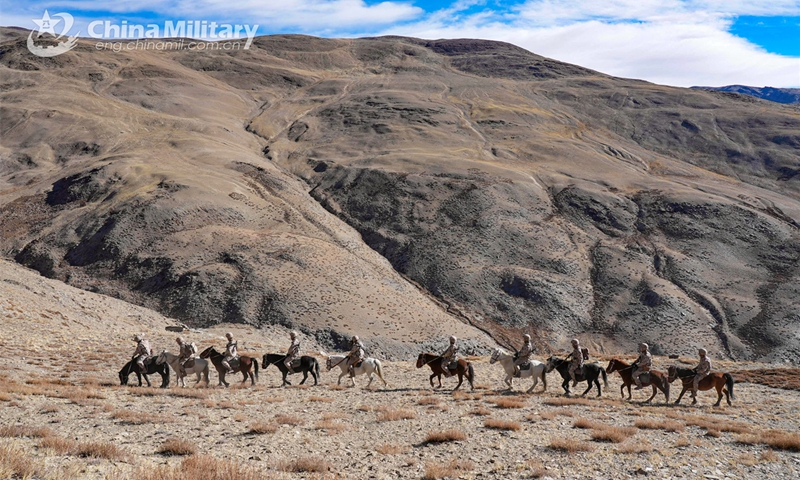 Soldiers assigned to a border defense company under the Chinese PLA Xinjiang Military Command steer their horses during a horse-riding patrol in the hinterland of the Karakoram mountain range at an altitude of over 4,200 meters on November 26, 2024. (eng.chinamil.com.cn/Photo by Dai Xuewu)