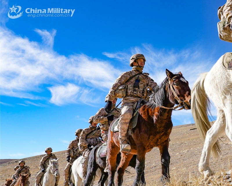 Soldiers assigned to a border defense company under the Chinese PLA Xinjiang Military Command steer their horses during a horse-riding patrol in the hinterland of the Karakoram mountain range at an altitude of over 4,200 meters on November 26, 2024. (eng.chinamil.com.cn/Photo by Dai Xuewu)
