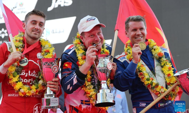 Winner Team Vietnam's Swedish driver Jonas Andersson (C), second-placed Victory Team's Swedish driver Erik Stark (L) and third-placed Sharjah Team's Canadian driver Rusty Wyatt react during the awarding ceremony for the Grand Prix of Sharjah at the U.I.M. World Championship in Sharjah, the United Arab Emirates (UAE), on Dec. 8, 2024. Photo: Xinhua