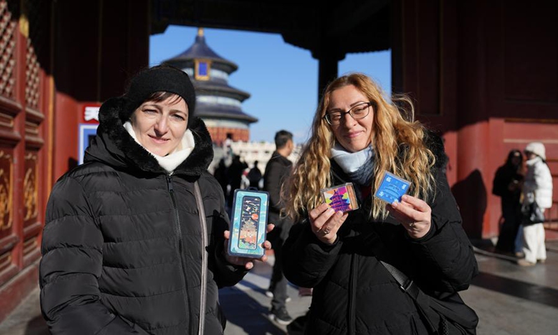 Tourists from Hungary show souvenirs bought at Tiantan (Temple of Heaven) Park in Beijing, capital of China, Dec. 5, 2024. Expanding visa-free policy is a milestone in China's journey toward greater openness and also shows its confidence on the global stage. So far, 38 countries enjoy unilateral visa-free access, and the maximum stay for visitors has been extended to 30 days as of Nov. 30. Photo: Xinhua