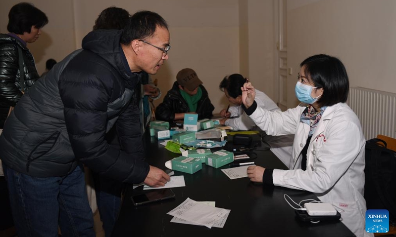 Chen Ji (R, front), a professor from Chengdu University of Traditional Chinese Medicine (TCM), advises a patient during an event in Vienna, Austria, Dec. 7, 2024. An event of TCM free consulting service was held here on Saturday. Photo: Xinhua