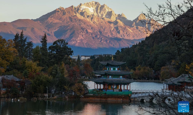 This photo taken from Heilongtan Park shows sunlight shining on the Yulong Snow Mountain in Lijiang City, southwest China's Yunnan Province, Dec. 9, 2024. (Photo: Xinhua)