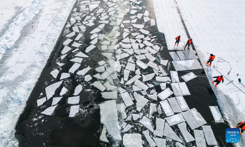 An aerial drone photo taken on Dec. 9, 2024 shows workers collecting ice from the Songhua River in Harbin, capital of northeast China's Heilongjiang Province. (Photo: Xinhua)