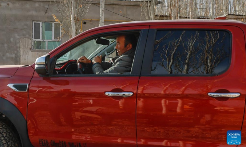 Memet Metseyit drives a car to the sandy land he contracted in Minfeng County, northwest China's Xinjiang Uygur Autonomous Region, Dec. 4, 2024. (Photo: Xinhua)