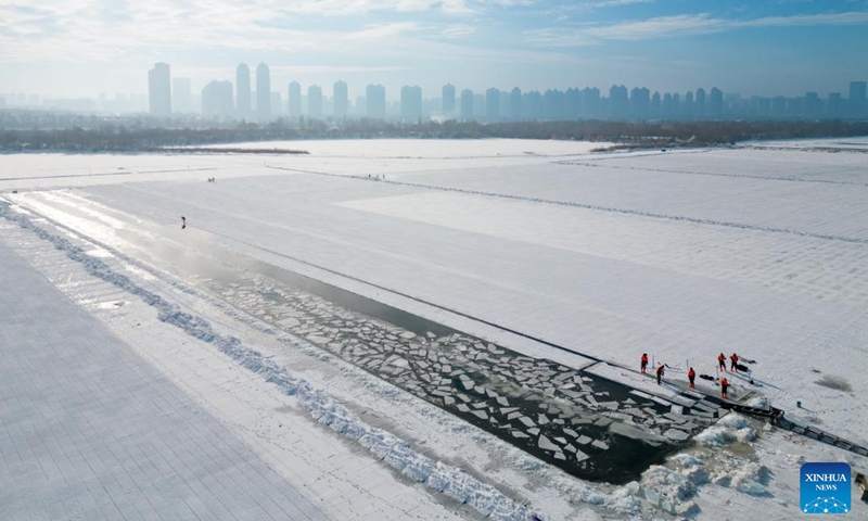 An aerial drone photo taken on Dec. 9, 2024 shows workers collecting ice from the Songhua River in Harbin, capital of northeast China's Heilongjiang Province. (Photo: Xinhua)