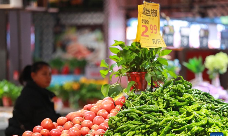 A customer selects vegetables at a supermarket in Congjiang County of Qiandongnan Miao and Dong Autonomous Prefecture, southwest China's Guizhou Province, Dec. 9, 2024. China's consumer price index (CPI), a main gauge of inflation, was up 0.2 percent year on year in November, the National Bureau of Statistics said Monday. (Photo: Xinhua)