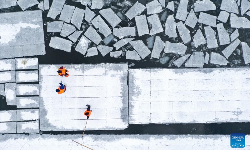 An aerial drone photo taken on Dec. 9, 2024 shows workers collecting ice from the Songhua River in Harbin, capital of northeast China's Heilongjiang Province. (Photo: Xinhua)
