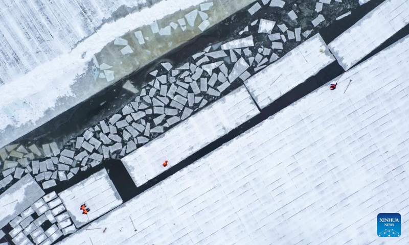 An aerial drone photo taken on Dec. 9, 2024 shows workers collecting ice from the Songhua River in Harbin, capital of northeast China's Heilongjiang Province. (Photo: Xinhua)
