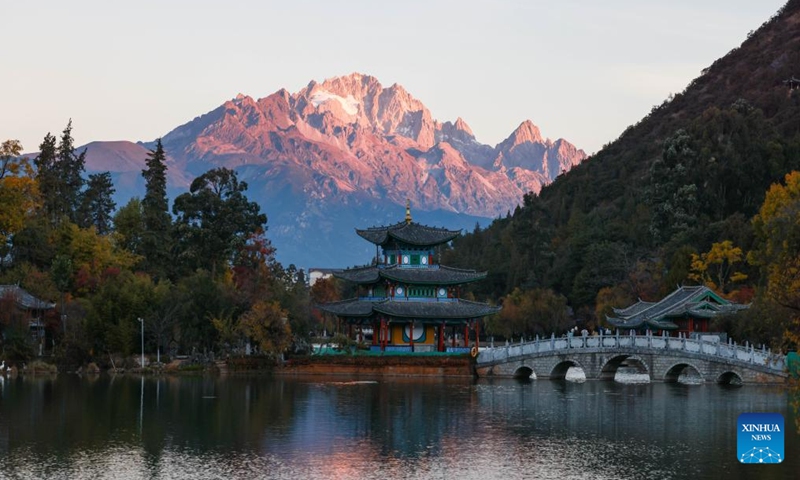 This photo taken from Heilongtan Park shows sunlight shining on the Yulong Snow Mountain in Lijiang City, southwest China's Yunnan Province, Dec. 9, 2024. (Photo: Xinhua)