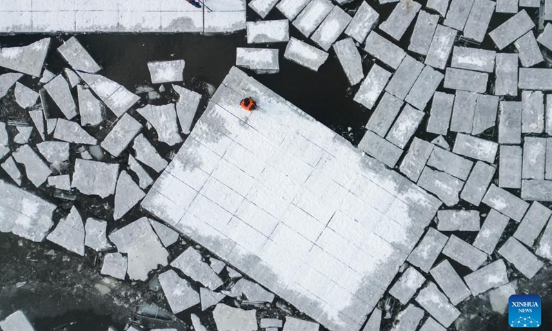 An aerial drone photo taken on Dec. 9, 2024 shows workers collecting ice from the Songhua River in Harbin, capital of northeast China's Heilongjiang Province. (Photo: Xinhua)