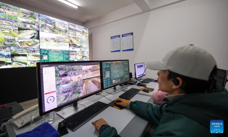 A staff member of cultural relics preservation monitors the condition of ancient roofed arch bridges in Taishun County of Wenzhou City, east China's Zhejiang Province, Dec. 12, 2024. (Photo: Xinhua)