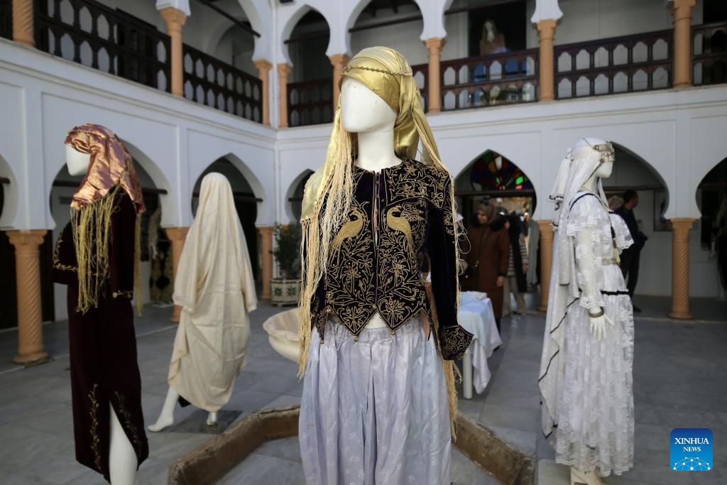 Traditional women's attire is displayed during an exhibition in Medea, Algeria, Dec. 12, 2024. (Photo: Xinhua)