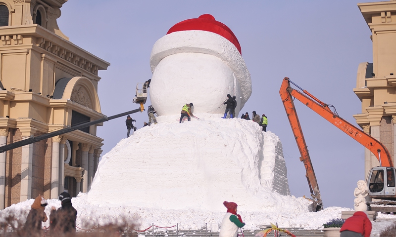 Workers carve a big snowman in a public square in Harbin, capital of Northeast China's Heilongjiang Province, on December 15, 2024. Their work attracted numerous tourists, many of whom stopped to watch and take pictures. Photo: VCG
