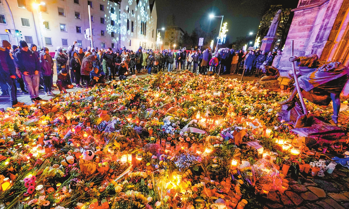 Local people gather at Johannis Church to mourn and pay tribute to the victims on December 21, 2024, one day after the deadly attack at the Christmas market in Magdeburg, Germany. A driver drove into a group of people at the market, killing at least five and injuring 200 others. Photo: VCG