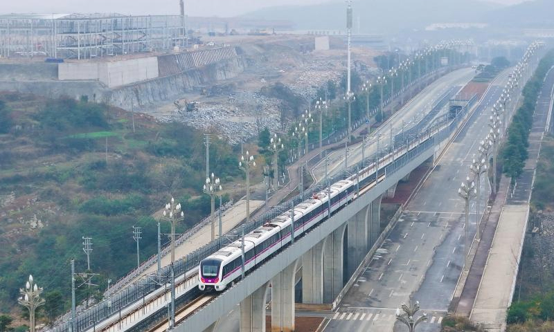 A drone photo shows a train of S1 line in Guiyang, southwest China's Guizhou Province, Dec. 28, 2024. Guiyang rail S1 line started operation on Saturday. The first phase of S1 line project has a total length of about 30 kilometers and 13 stations, and will become an important passage from Gui'an New Area to the urban area of Guiyang. (Photo by Long Jianrui/Xinhua)

