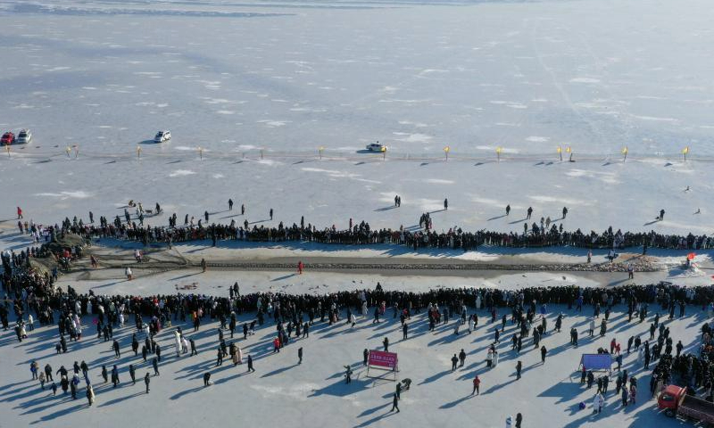 An aerial drone photo taken on Dec. 28, 2024 shows tourists watching winter fishing at Chagan Lake in Songyuan City of northeast China's Jilin Province. A winter fishing-themed cultural and tourism festival kicked off on Saturday at Chagan Lake.
Chagan Lake, located in Songyuan City of Jilin Province, is the largest natural lake of the province with abundant fishery resources. Locals living by Chagan Lake have kept alive the tradition of ice fishing by hand-drilling holes through the thick ice and casting nets into the icy waters to catch fish.
The winter fishing at Chagan Lake, included in the national intangible cultural heritage list, has become a famous tourism attraction in the city. (Xinhua/Zhang Nan)