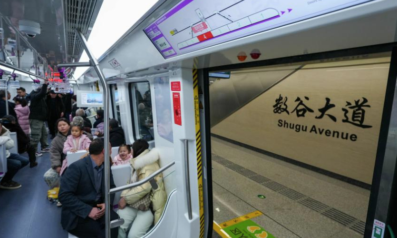 People take a train of S1 line in Guiyang, southwest China's Guizhou Province, Dec. 28, 2024. Guiyang rail S1 line started operation on Saturday. The first phase of S1 line project has a total length of about 30 kilometers and 13 stations, and will become an important passage from Gui'an New Area to the urban area of Guiyang. (Photo by Long Jianrui/Xinhua)