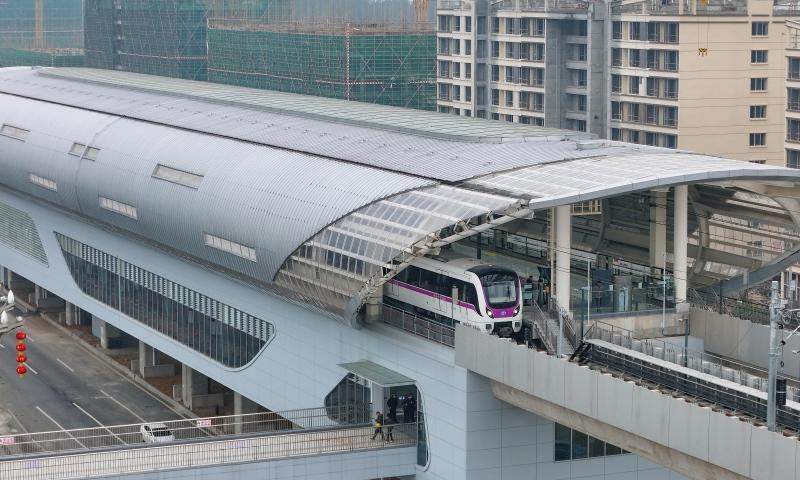 A drone photo shows a train of S1 line departing from Dalongjing station in Guiyang, southwest China's Guizhou Province, Dec. 28, 2024. Guiyang rail S1 line started operation on Saturday. The first phase of S1 line project has a total length of about 30 kilometers and 13 stations, and will become an important passage from Gui'an New Area to the urban area of Guiyang. (Photo by Long Jianrui/Xinhua)