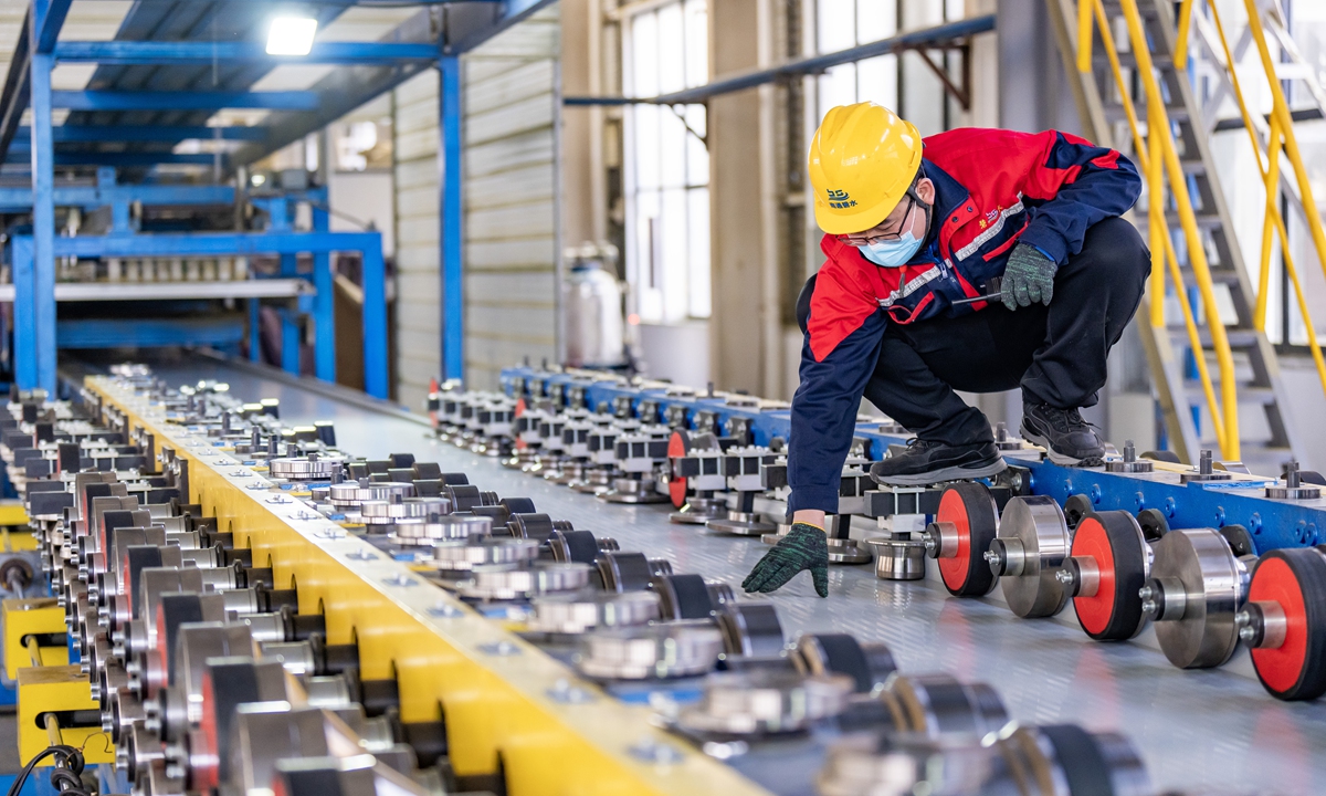 A worker inspects production of color steel sheet products at a plant in Nantong, East China's Jiangsu Province on December 24, 2024. In the first 10 month, the province's industrial production saw a stable performance, with value added of industrial firms above the designated size growing by 7.6 percent year-on-year, according to media reports. Photo:VCG