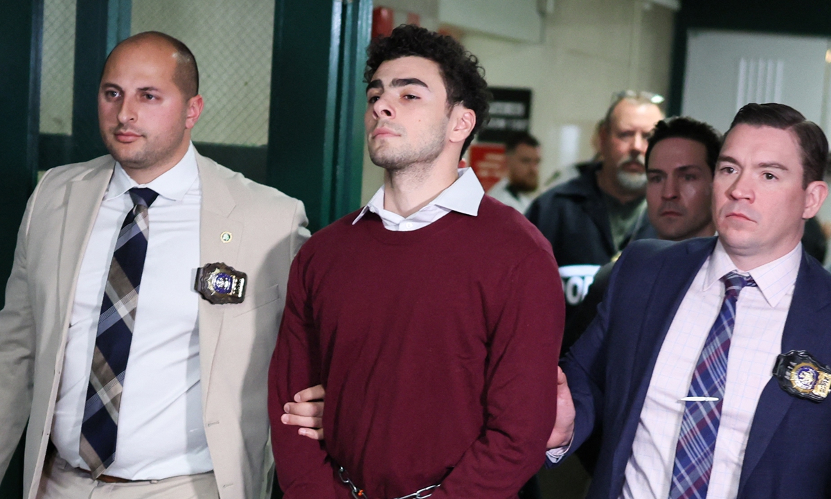 Luigi Mangione (center) leaves the Manhattan Criminal Court in New York on December 23, 2024. Mangione, 26, is accused of shooting UnitedHealthcare chief executive Brian Thompson on a Manhattan street on December 4. He pleaded not guilty to murder and terror charges while his attorney complained that statements coming from New York's mayor would make it tough for him to receive a fair trial. Photo: AFP
