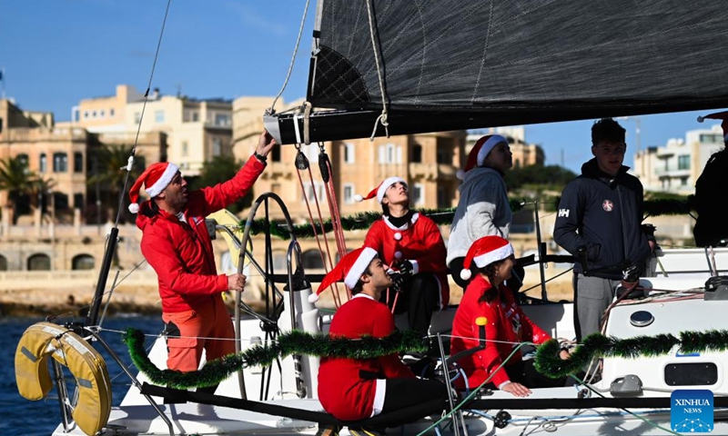 People take part in the traditional Boxing Day Fun Race for charity in Ta' Xbiex, Malta, Dec. 26, 2024. (Photo by Jonathan Borg/Xinhua)
