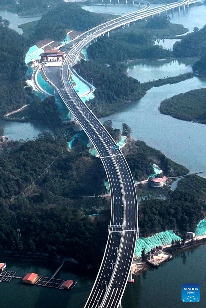 An aerial drone photo taken on Dec. 24, 2024 shows Longmen Bridge in Qinzhou, south China's Guangxi Zhuang Autonomous Region. Longmen Bridge, the longest cross-sea bridge in south China's Guangxi Zhuang Autonomous Region, opened to traffic on Sunday, slashing the time needed to travel between the Qinzhou Port and Fangchenggang Port from 1.5 hours to 25 minutes. (Xinhua/Zhang Ailin)