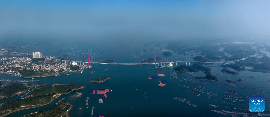 This stitched aerial drone photo taken on Dec. 24, 2024 shows Longmen Bridge in Qinzhou, south China's Guangxi Zhuang Autonomous Region. Longmen Bridge, the longest cross-sea bridge in south China's Guangxi Zhuang Autonomous Region, opened to traffic on Sunday, slashing the time needed to travel between the Qinzhou Port and Fangchenggang Port from 1.5 hours to 25 minutes. (Xinhua/Zhang Ailin)