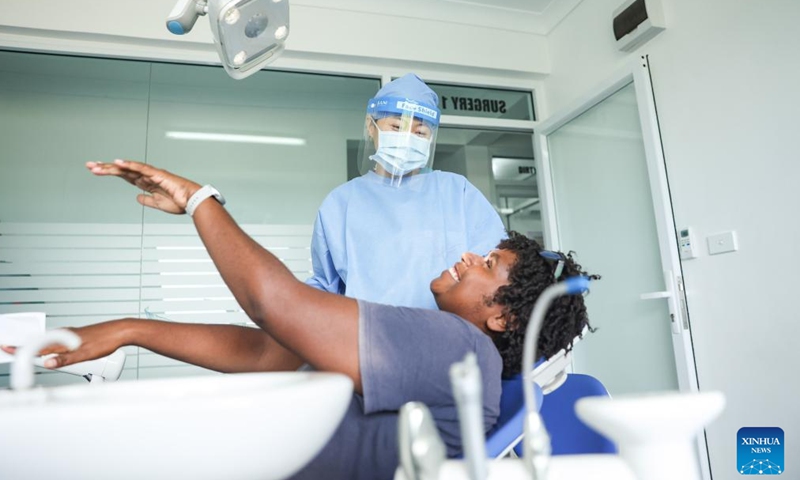 Li Wei, a dentist of Chinese medical team, communicates with a patient at Vila Central, the main hospital in Port Vila, Vanuatu, on Jan. 2, 2025. Members of the third batch of Chinese medical team to Vanuatu have rendered professional service to more than 1,800 patients since they were deployed in the Pacific Island nation in September 2024.