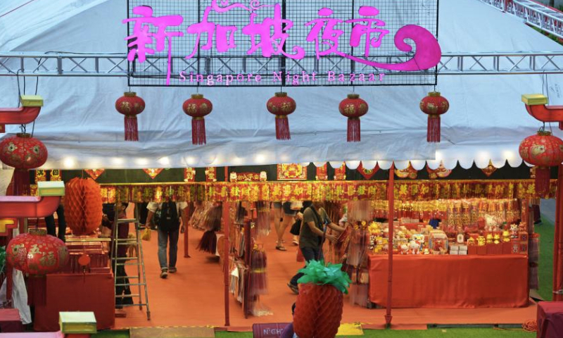 People visit a temporary neighborhood Lunar New Year night market in Singapore's Bukit Panjang on Jan. 6, 2025. (Photo by Then Chih Wey/Xinhua)