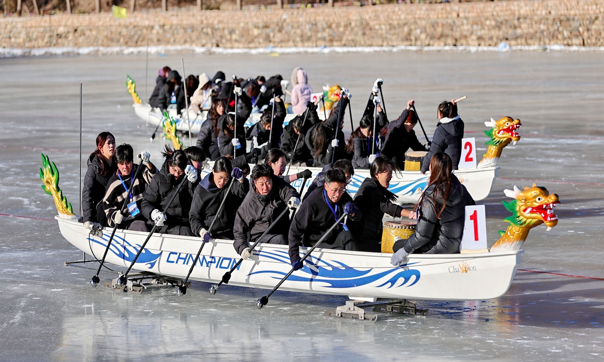 People participate in an ice dragon boat race in Qinhuangdao, North China's Hebei Province on January 8, 2025. The ice dragon boat competition at the 5th Hebei Ice and Snow Sports Games features six age categories, with a total of 279 athletes representing six cities competing. Photo: VCG