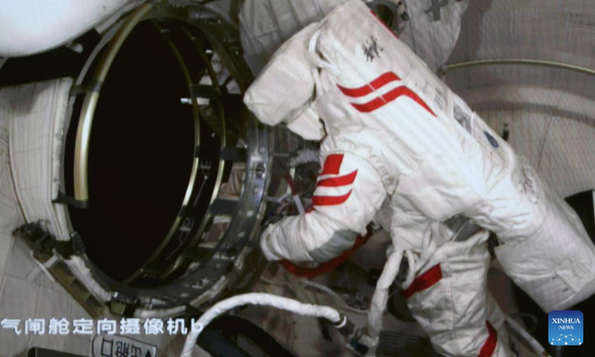 This screen image captured at Beijing Aerospace Control Center on Jan. 20, 2025 shows Shenzhou-19 astronaut Cai Xuzhe working inside the airlock cabin of China's orbiting space station. (Xinhua/Liu Fang)