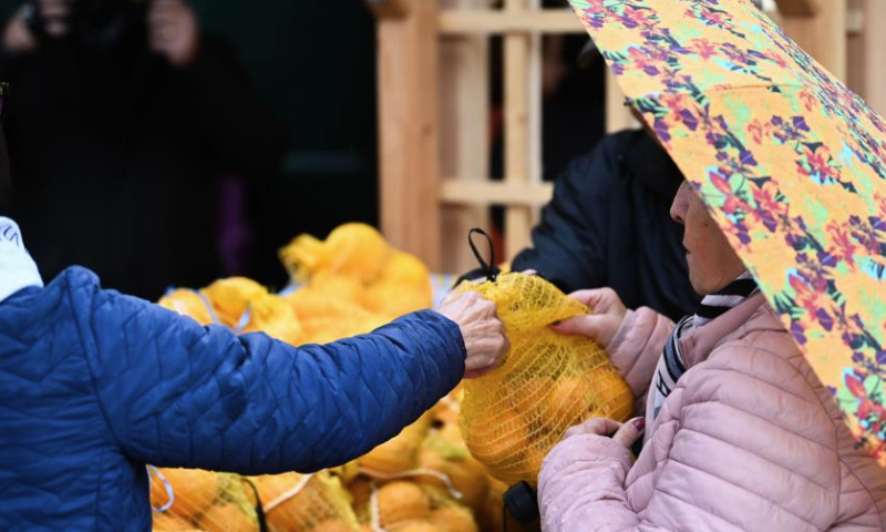 People buy oranges at the San Anton Palace in Attard, Malta, on Jan. 12, 2025. The annual citrus festival was held on Sunday at the San Anton Palace in Attard, Malta. (Photo by Jonathan Borg/Xinhua)