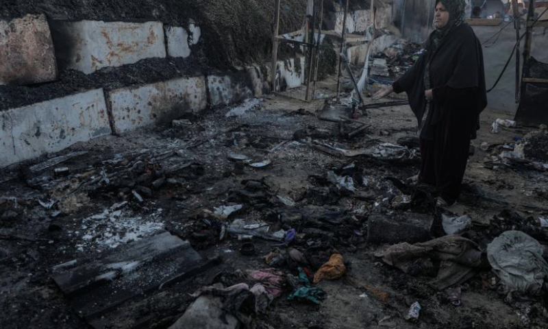 A Palestinian is seen at the site of destroyed tents after an Israeli bombardment, in Deir al-Balah city in the central Gaza Strip, on Jan. 14, 2025. (Photo by Rizek Abdeljawad/Xinhua)